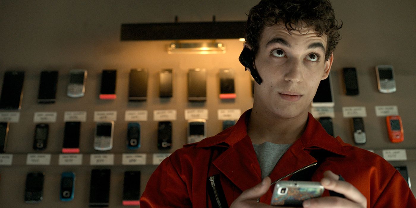 Rio standing in front of a wall of phones in Money Heist.