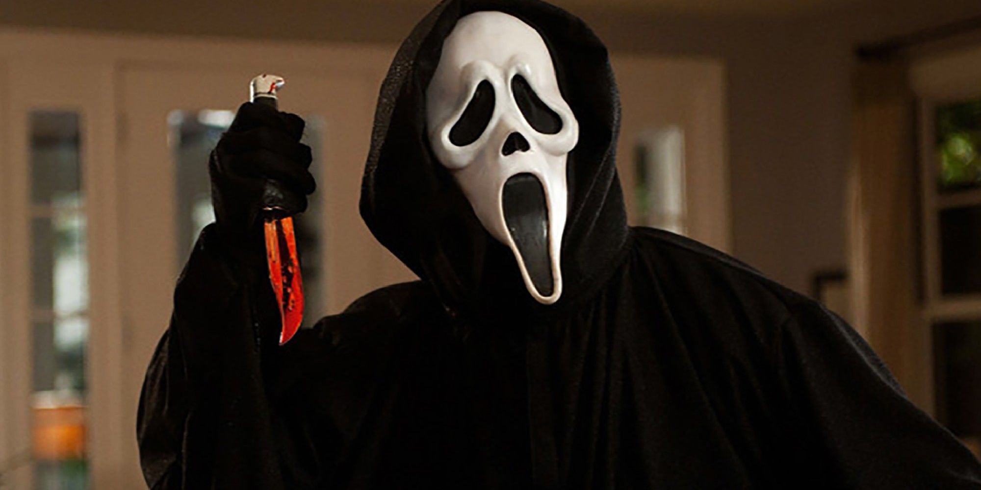 Ghostface raises a bloody knife in Scream