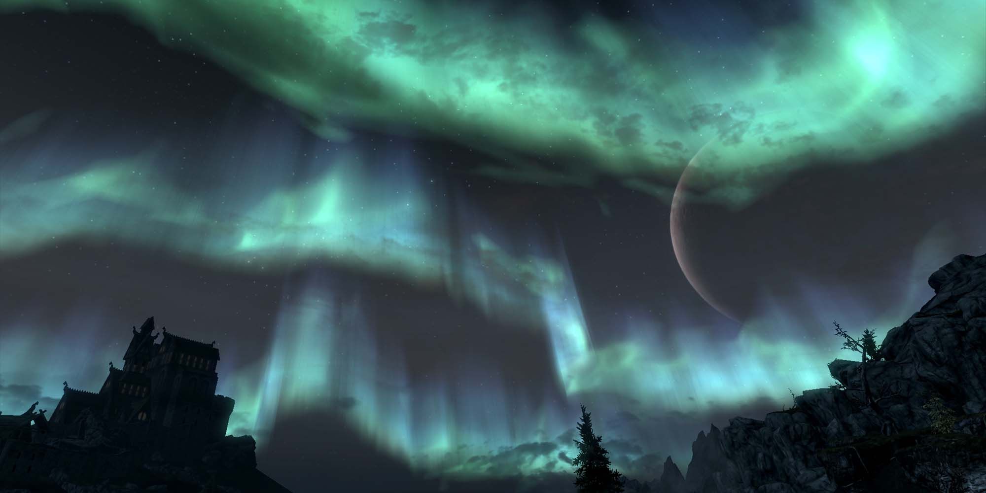 green and blue auroras over tress and masser