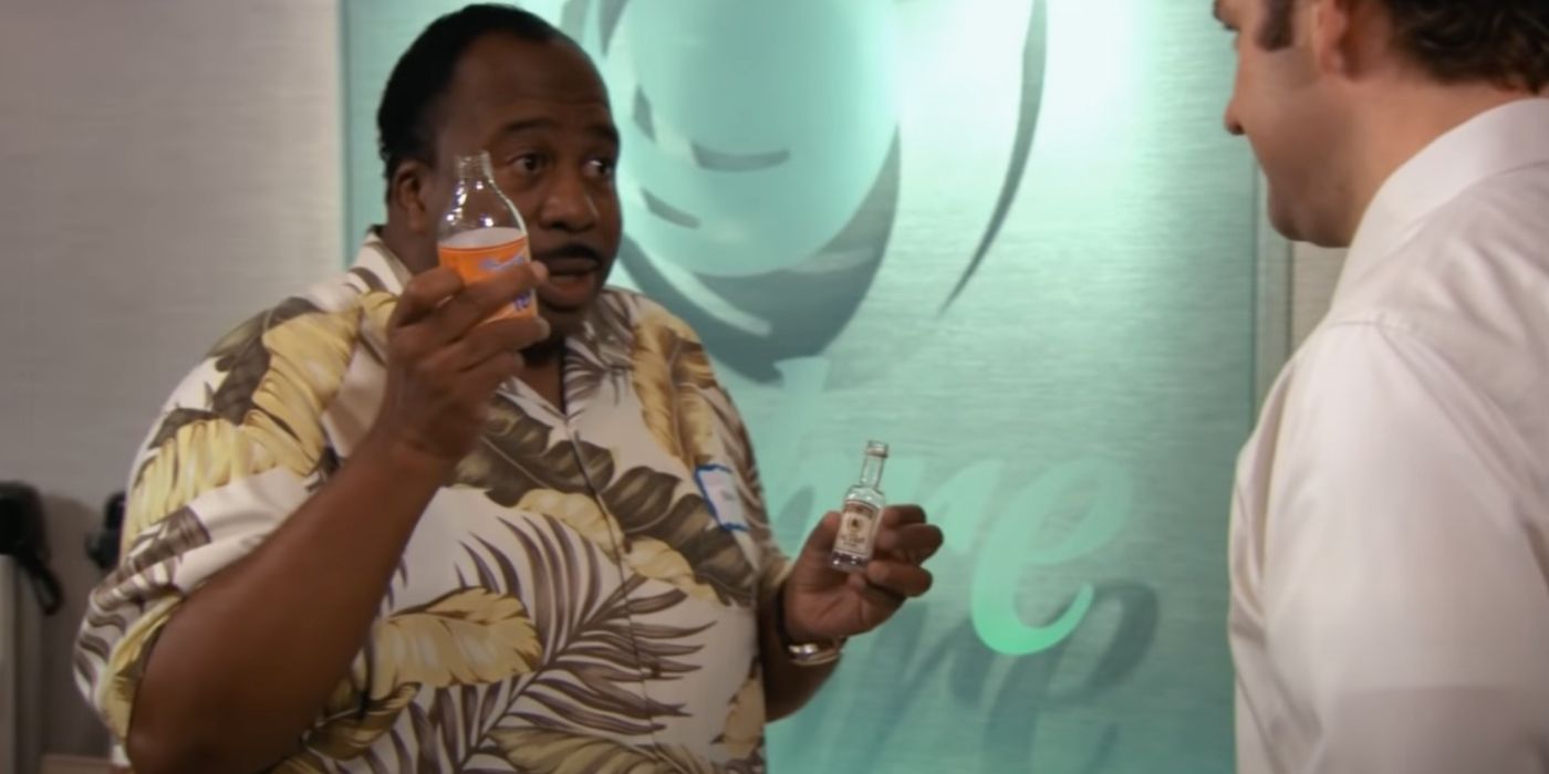 Stanely holding an iced tea in front of Jim in Florida on The Office