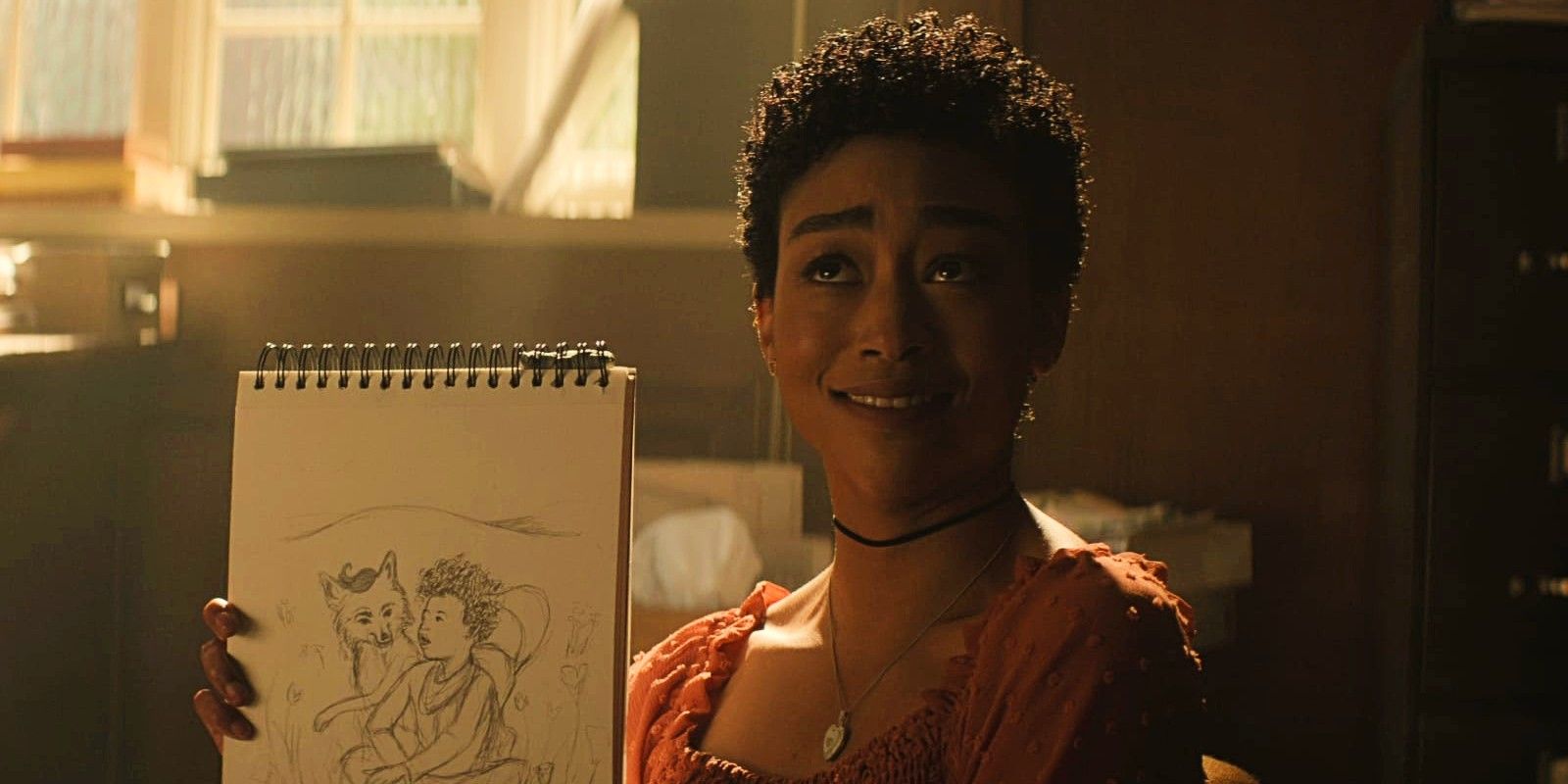 Tati Gabrielle as Marianne showing her illustration on You Season 3