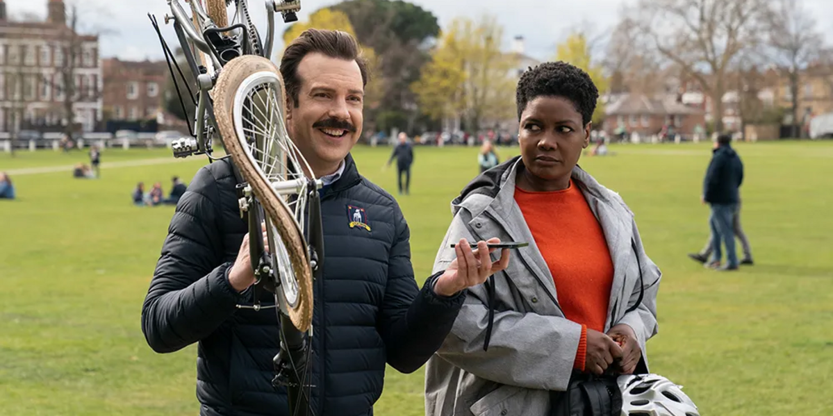 Ted carries a bike with Dr. Sharon