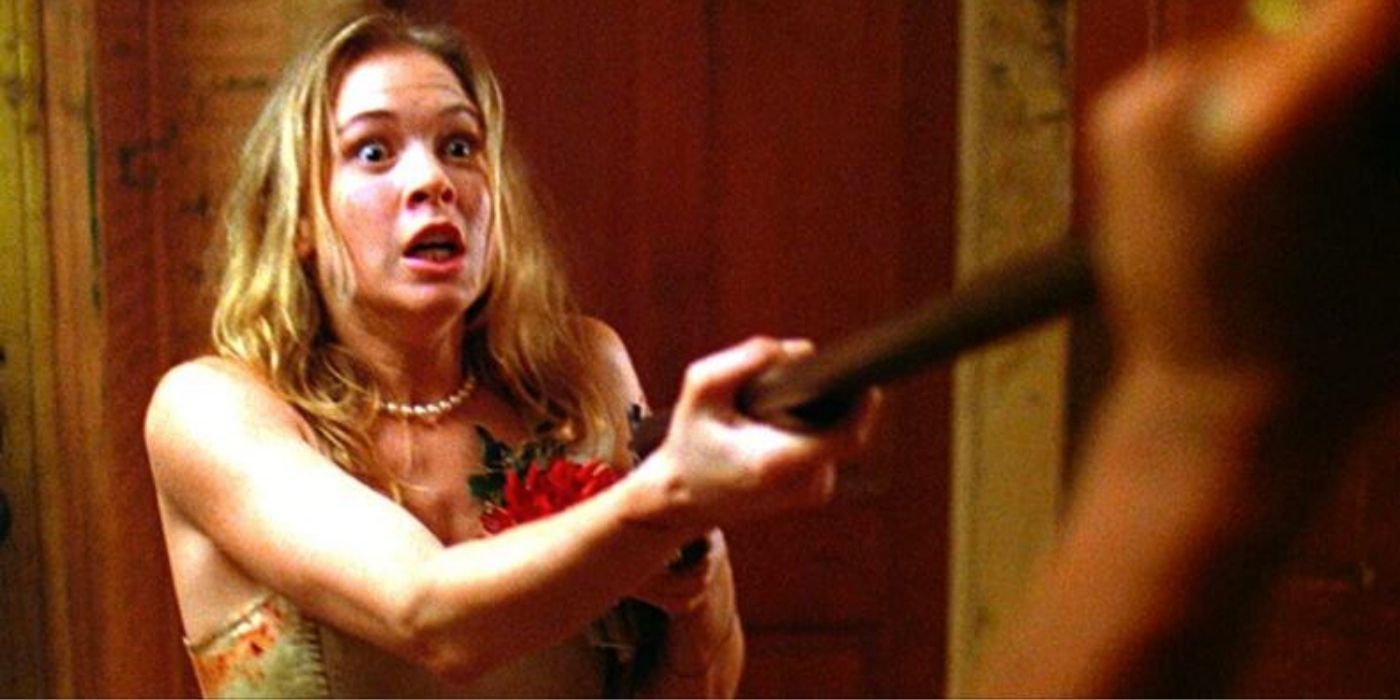 A scared Jenny holding a gun in The Texas Chainsaw Massacre The Next Generation