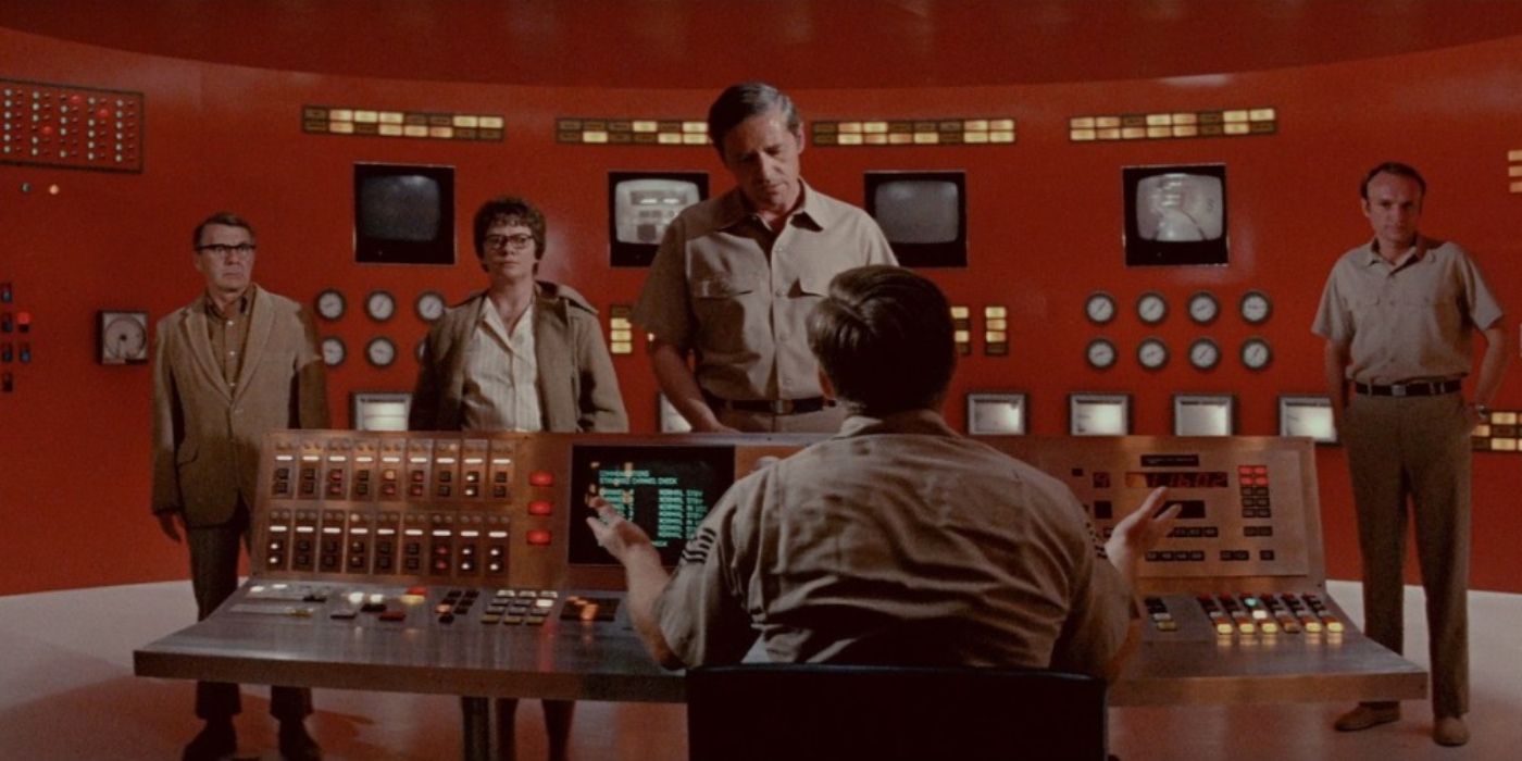 A man looks at a group of people in a control room in The Andromeda Strain.
