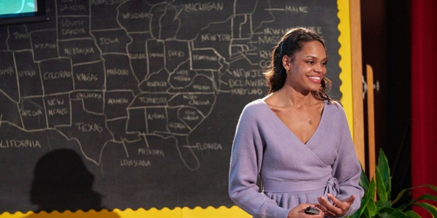 Michelle Young smiling while standing in front of a blackboard in The Bachelorette