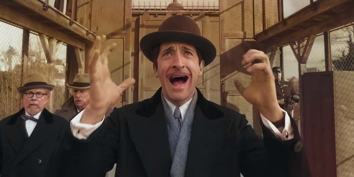 Adrien Brody screaming with his hands up in The French Dispatch
