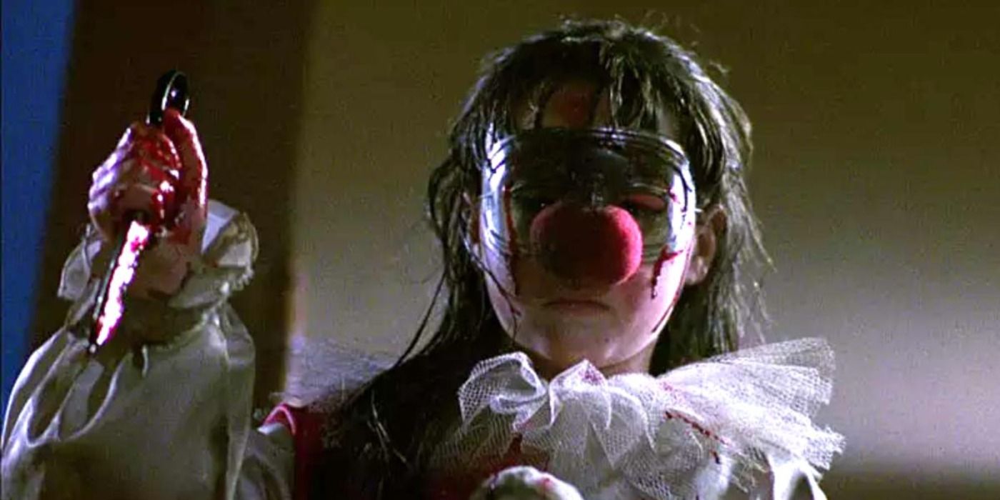 Jamie raises a bloody knife while dressed as a clown in Halloween 4.