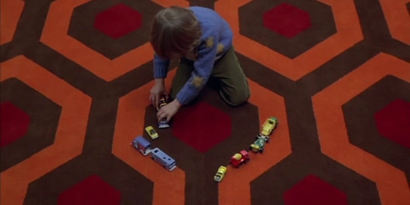 Danny playing with toy cars in The Shining