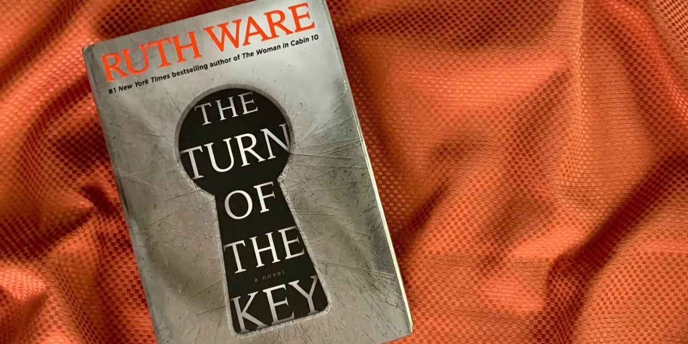 The Turn of the Key book on orange fabric