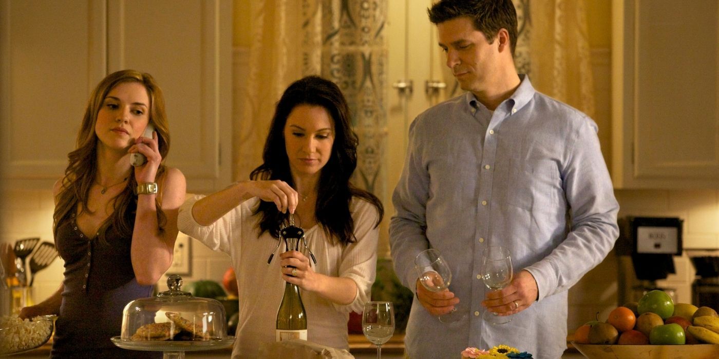 Three people standing in a kitchen in The Vampire DIaries