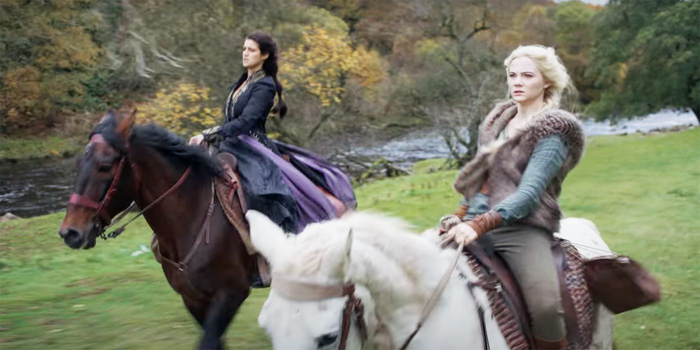 Yennefer and Ciri ride horses in a green field in The Witcher.
