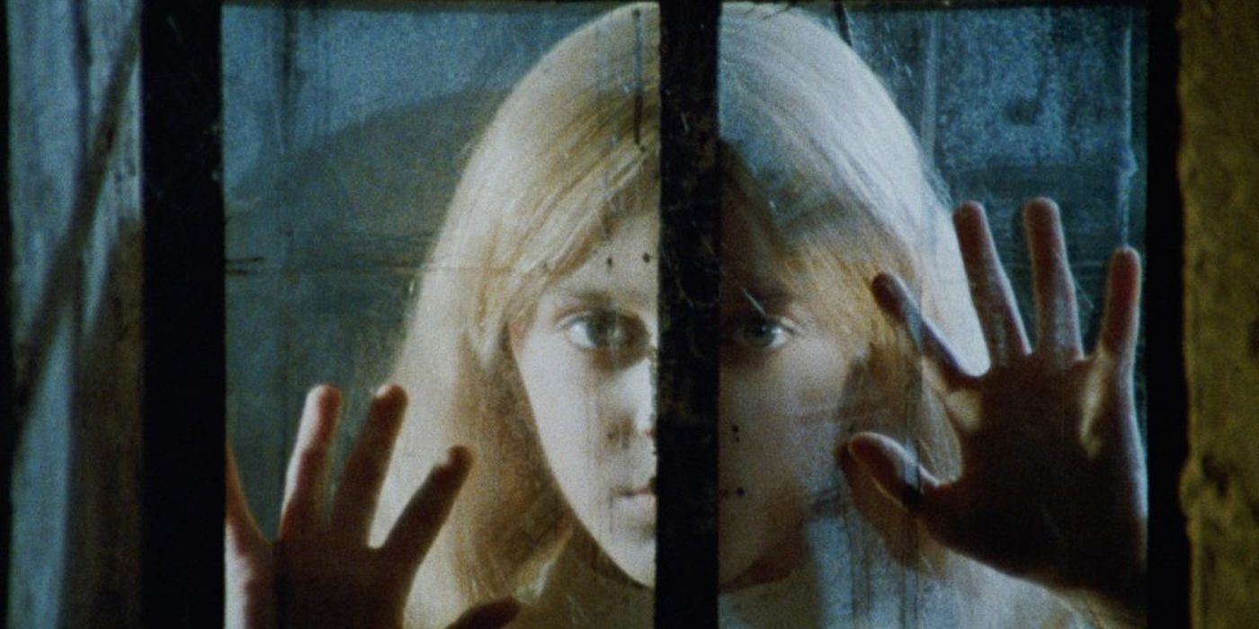 The ghostly Melissa looks out a window in Kill Baby Kill.
