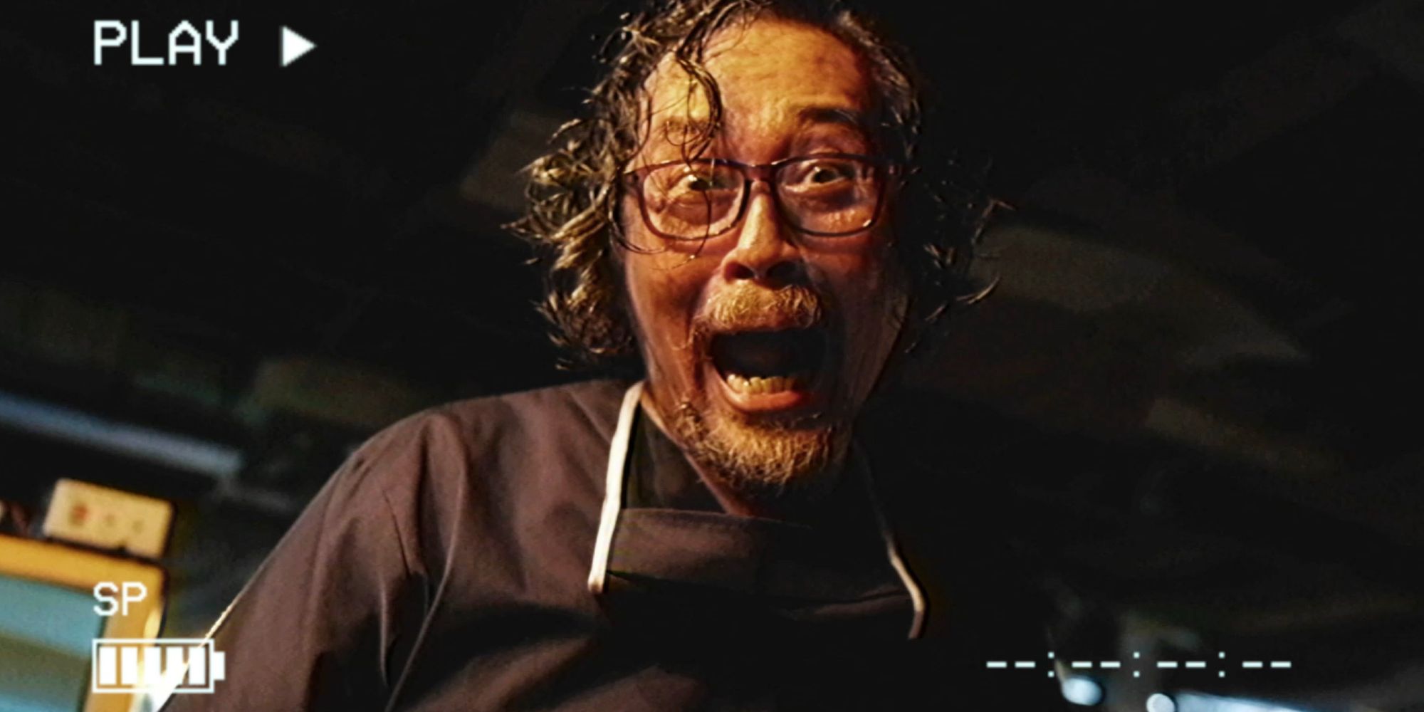 A man screams while looking into the camera in VHS94