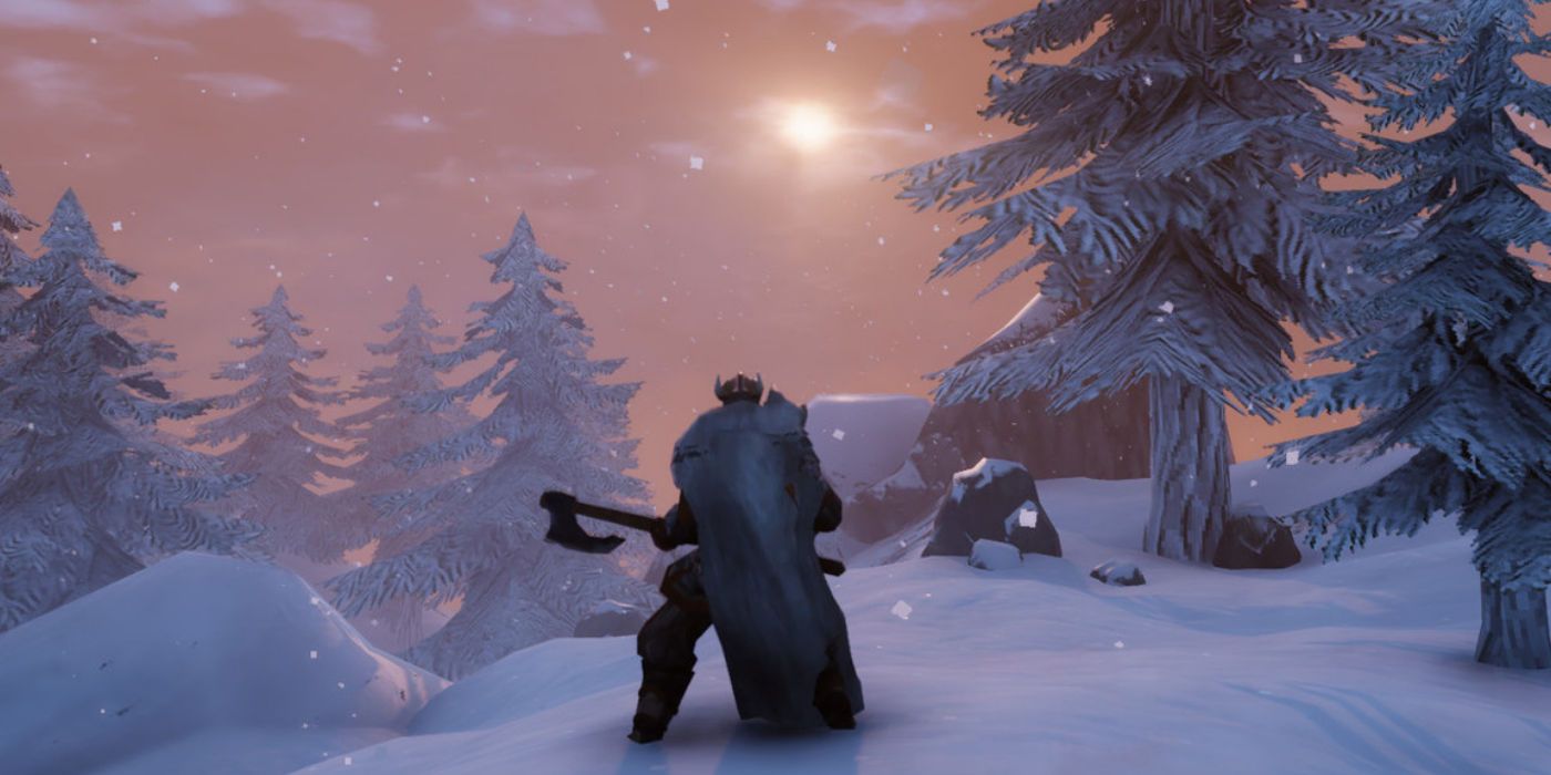 A player wields an axe in the snow in Valheim.