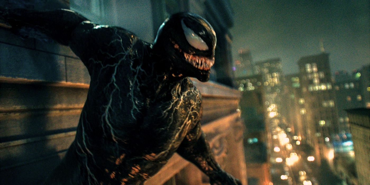 Venom hangs on the side of a building in Venom: Let There Be Carnage.