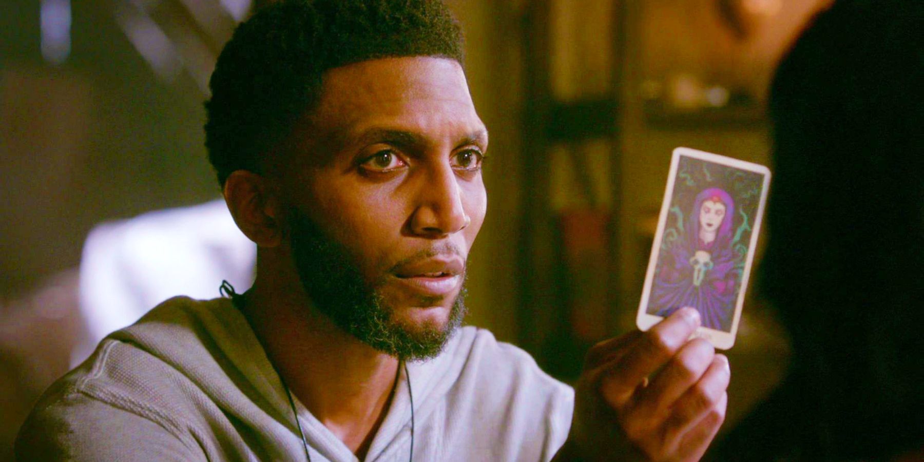 Vincent Griffith holds up a tarot card in The Originals.