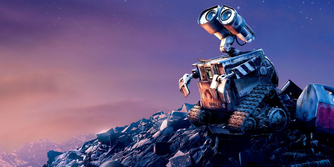 WALL-E on top of a pile of garbage looking up at the sky