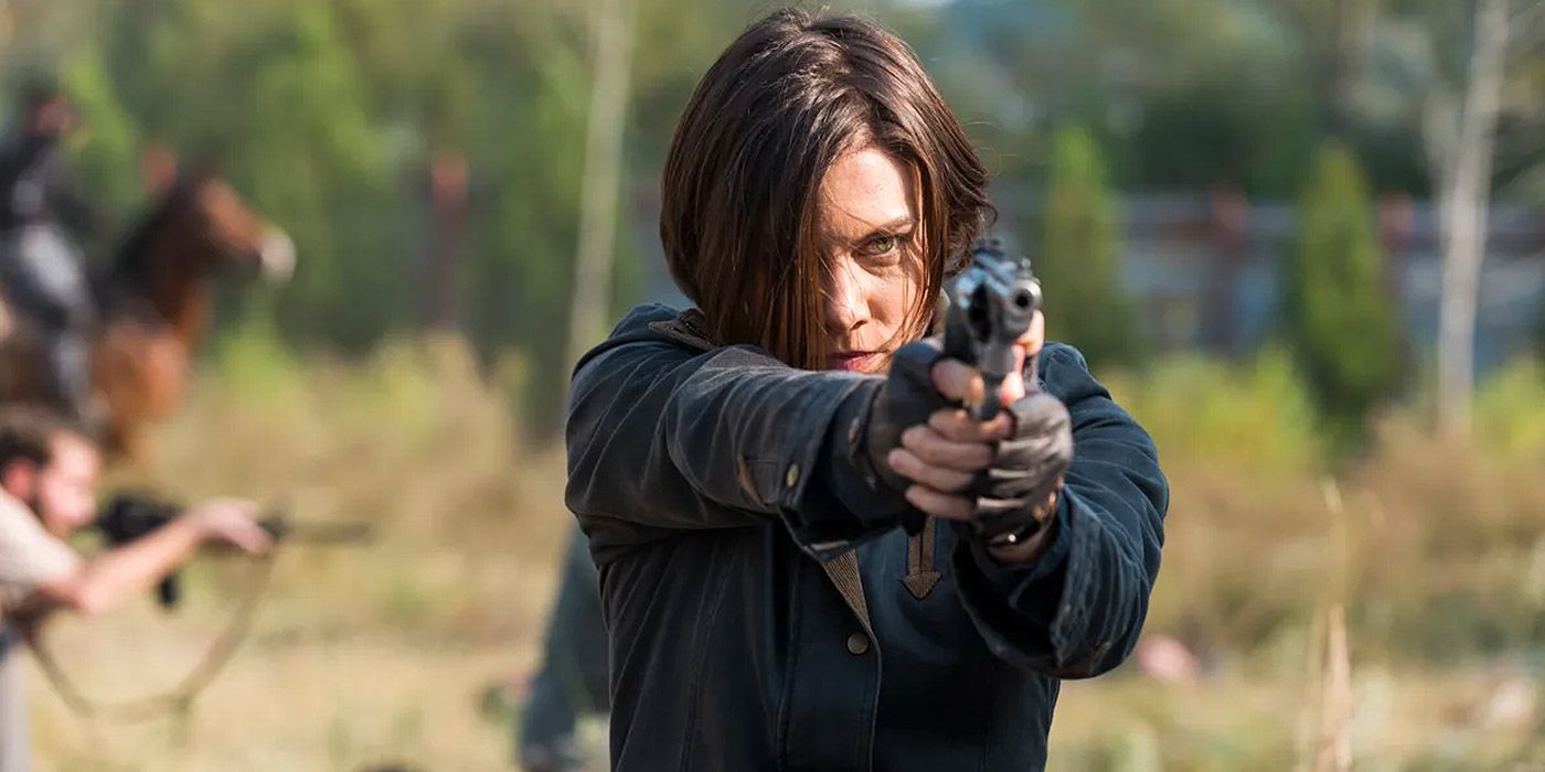 Carol aiming a gun at a walker in The Walking Dead.