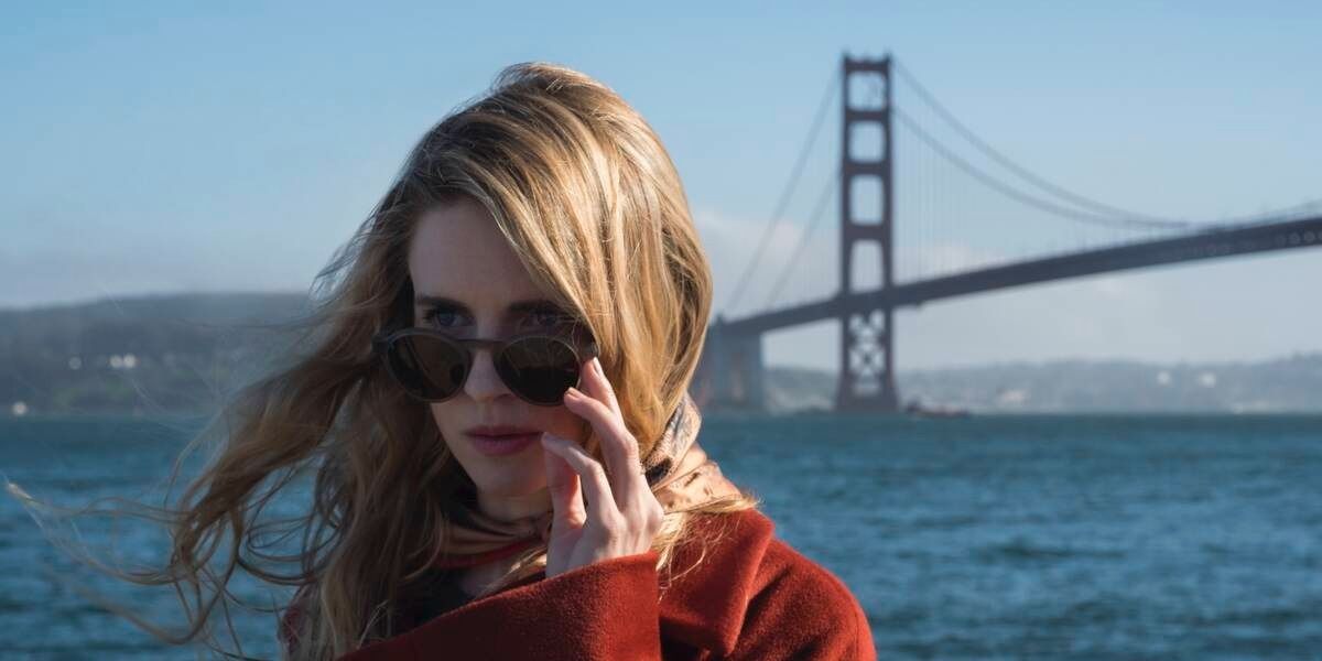 a blonde woman stood beside the Golden Gate bridge wearing sunglasses in The OA