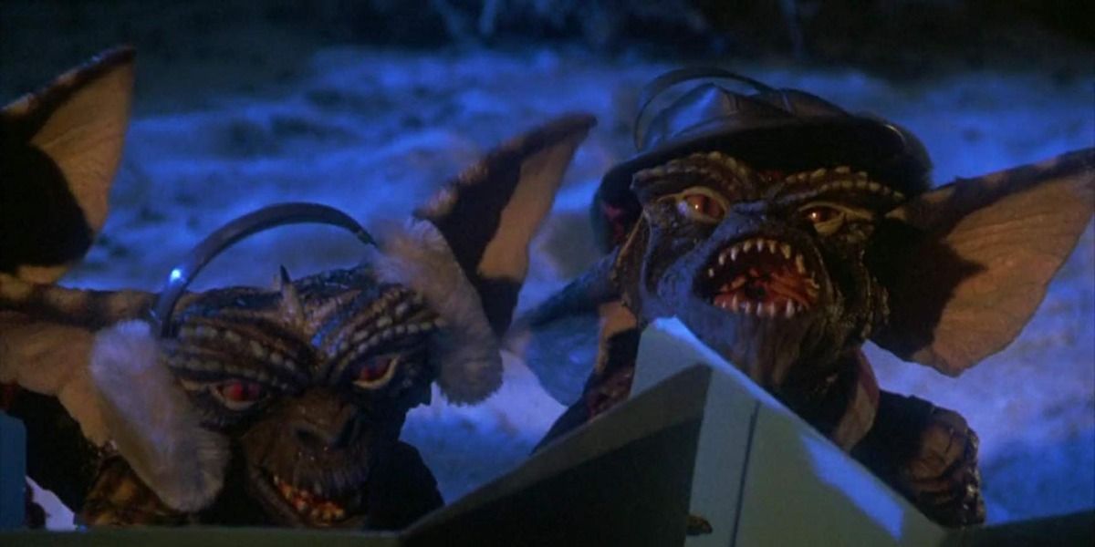A group of Gremlins, one is wearing earmuffs, one is wearing a hat.