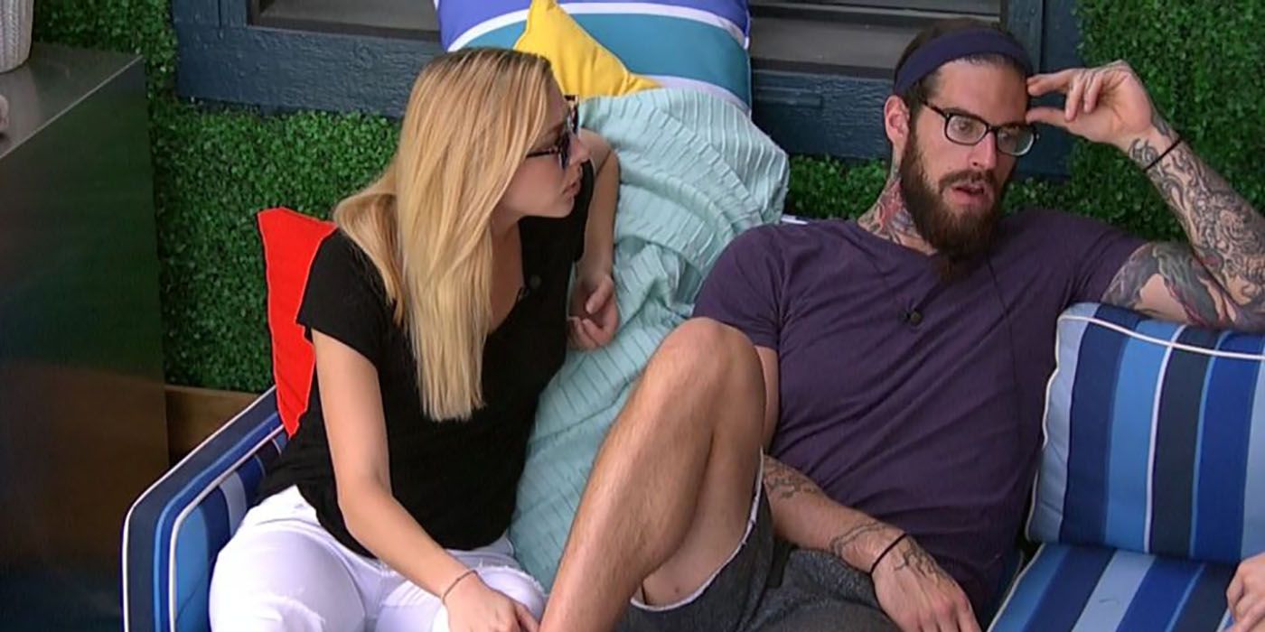 Liz and Austin sitting on the couch outside on Big Brother, Austin pulling away from Liz looking upset.