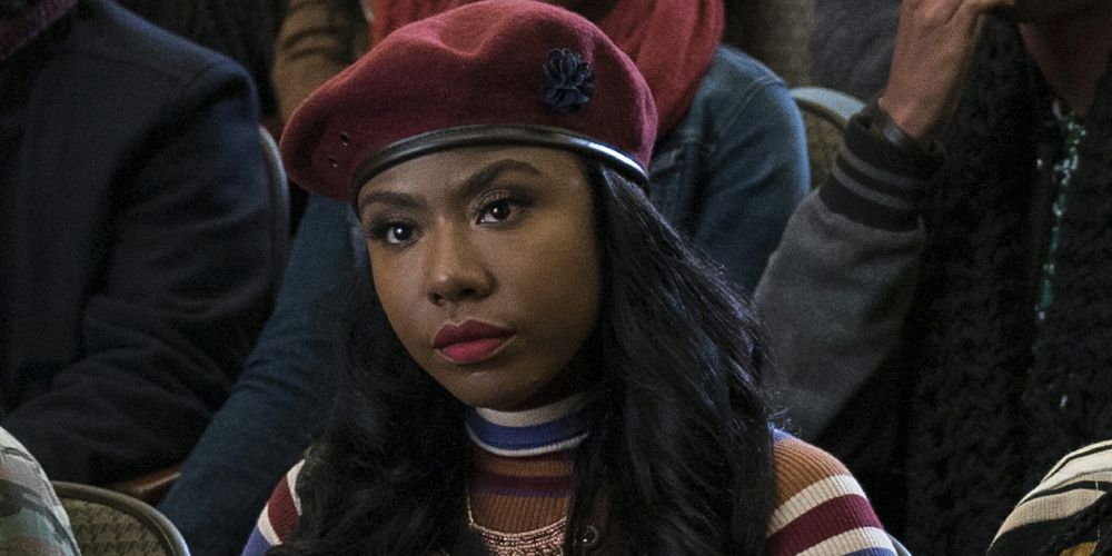 Kelsey wears a red beret at a rally in Dear White People