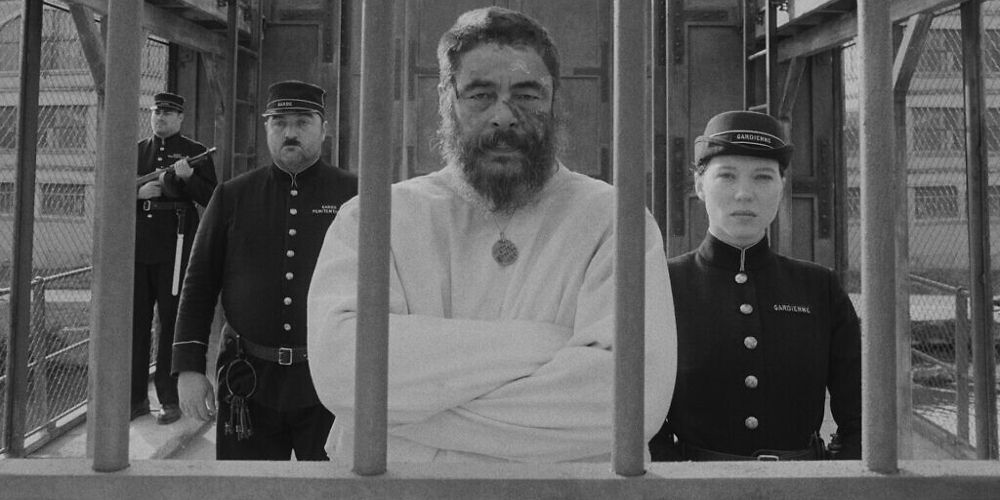 Moses is flanked by guards in prison in The French Dispatch