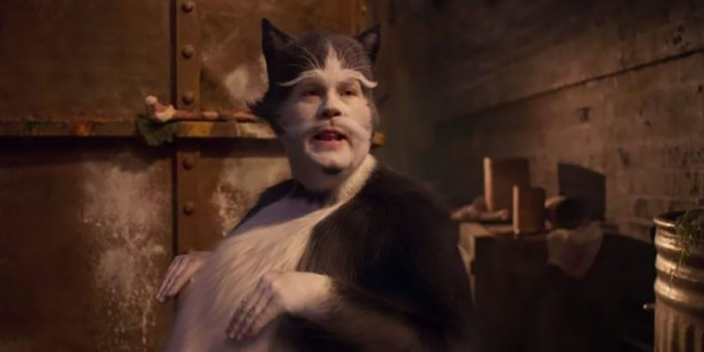 James Corden in cats, dressed as a furry cat with his hands in front of him, wrists down.