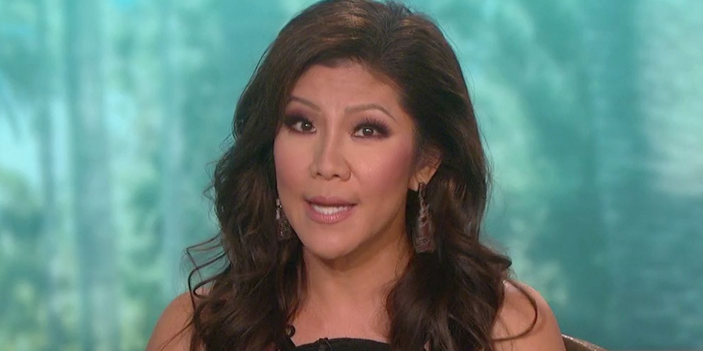 Julie Chen from The Talk, in mid-sentence with a green blurred background.