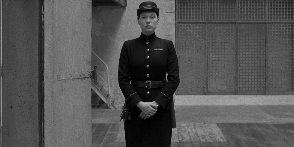 Simone stands alone in the prison yard in The French Dispatch