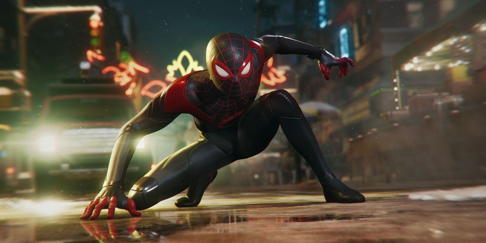 Spider Man crouches in the street at night in Marvel's Spider Man: Miles Morales