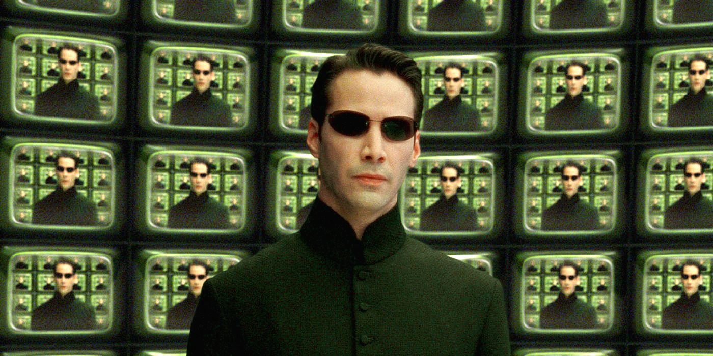 Neo standing in front of multiple television screens in The Matrix Reloaded