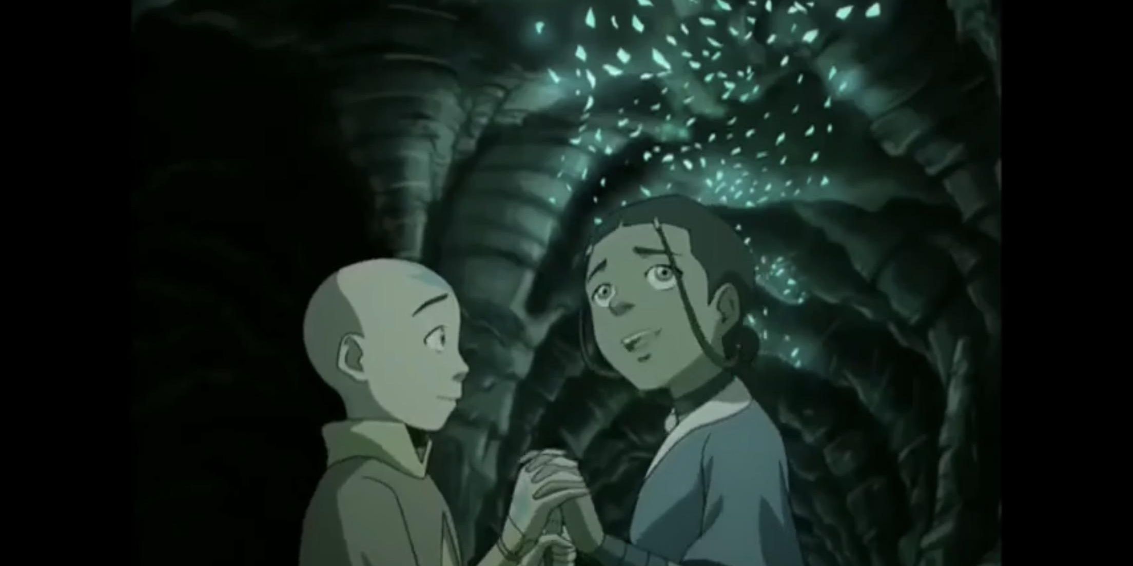 Aang and Katara holding hands in the cave of two lovers