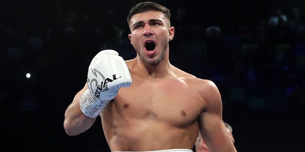 Tommy Fury holds up a glove during a boxing match
