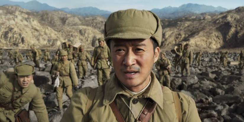 A group of Chinese soldiers walk over mountains in The Battle of Lake Changjin