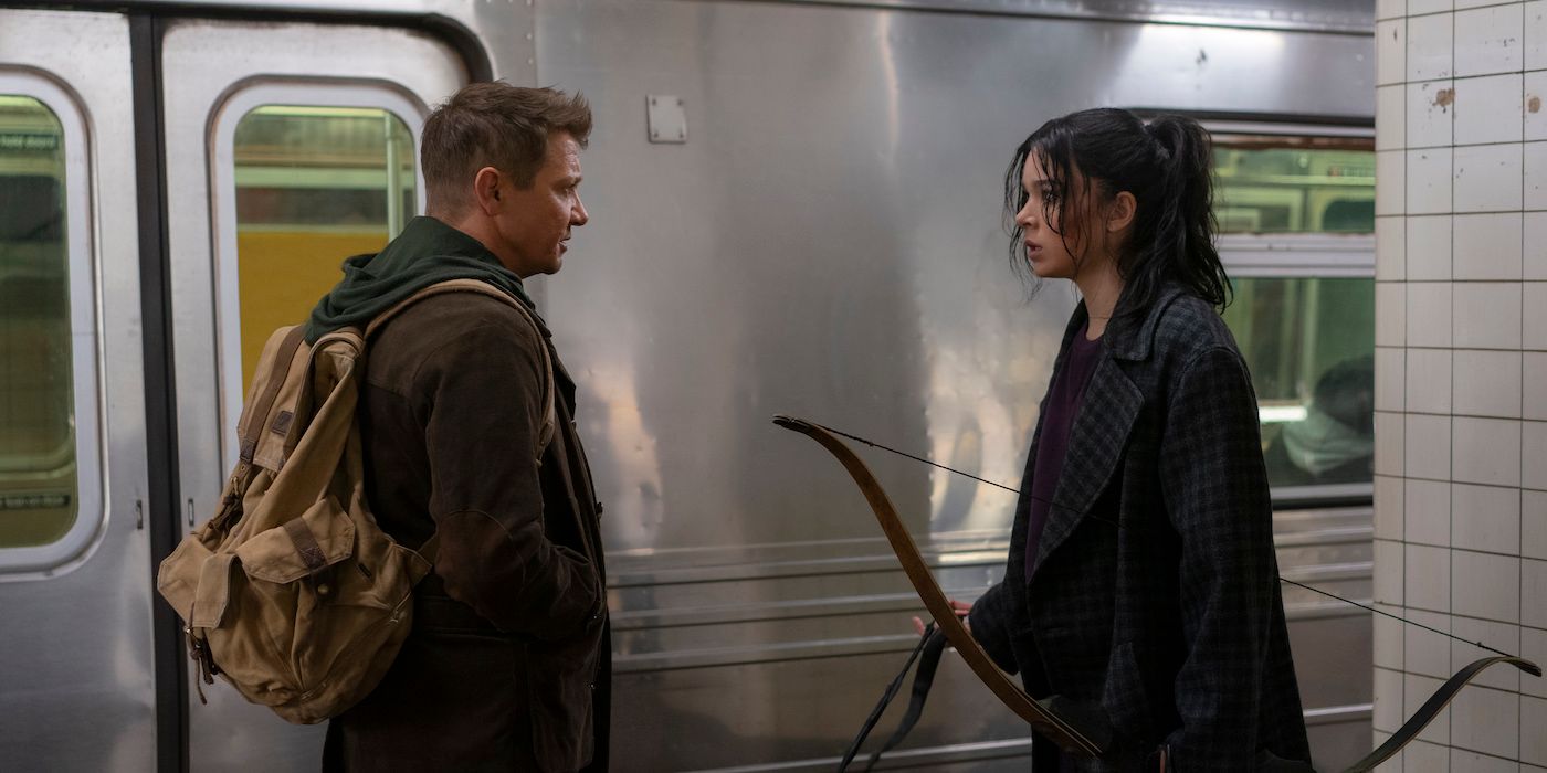 Clint and Kate stand in front of a train in Hawkeye.