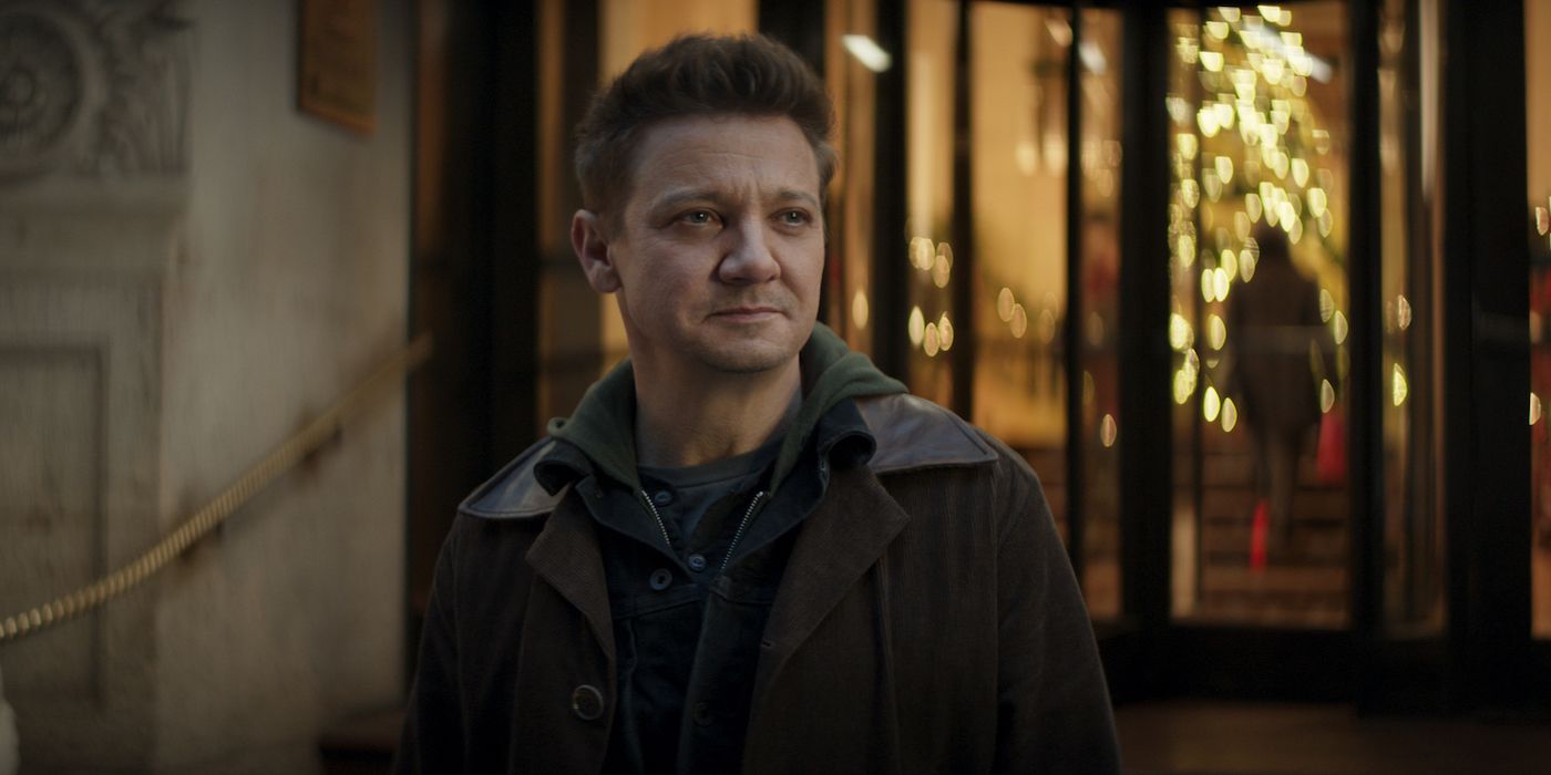 Clint Barton smiles in front of a building in Hawkeye