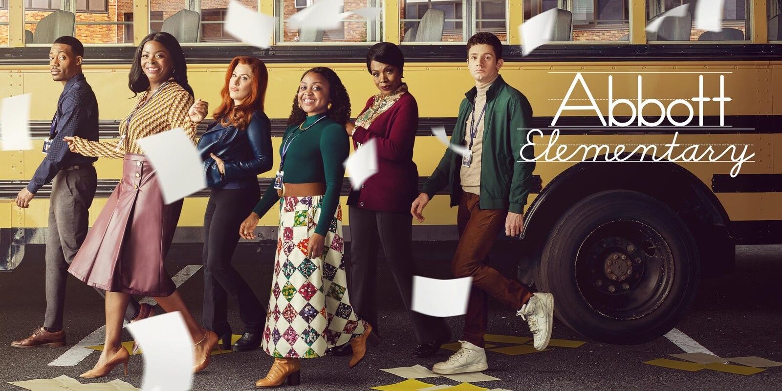 The cast of Abbott Elementary walks on a promotional image for the show