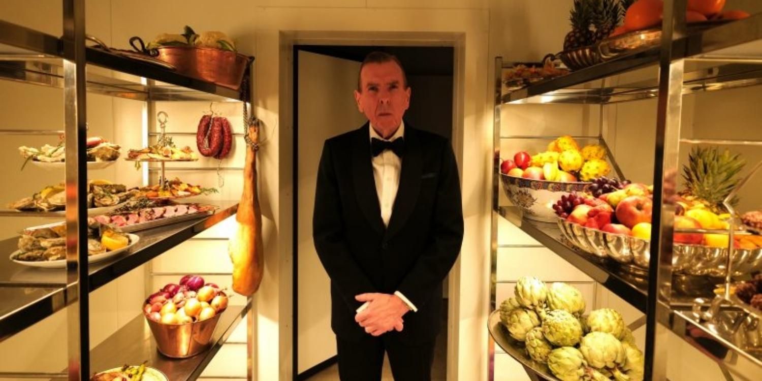Alistair Gregory in a tuxedo standing in a pantry in Spencer