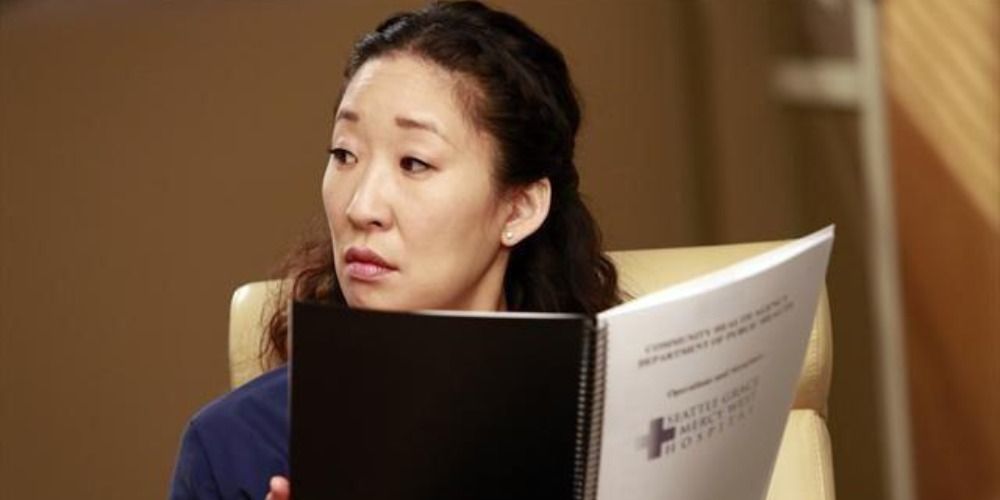 An image of Cristina reading a booklet in Grey's Anatomy