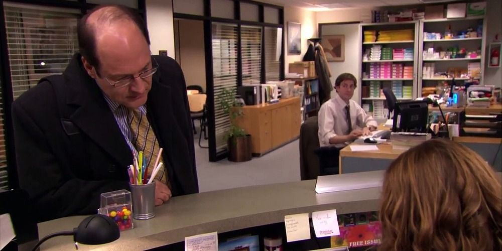 An image of a salesman talking to Pam in The Office