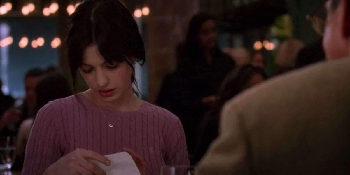 Andy Sachs opens an envelope in The Devil Wears Prada