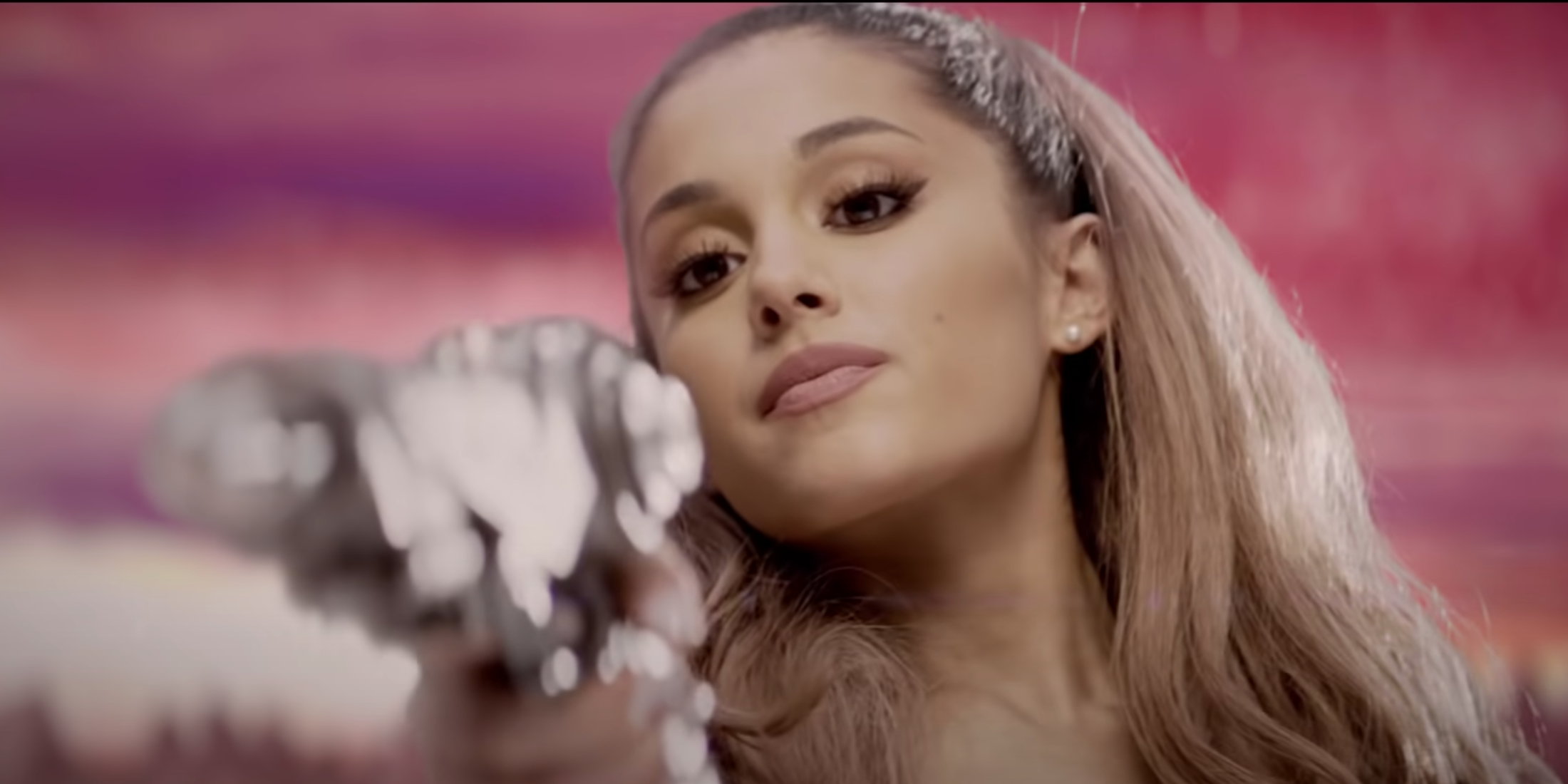 An image of Ariana Grande pointing a ray gun at the camera in the music video for Break Free.