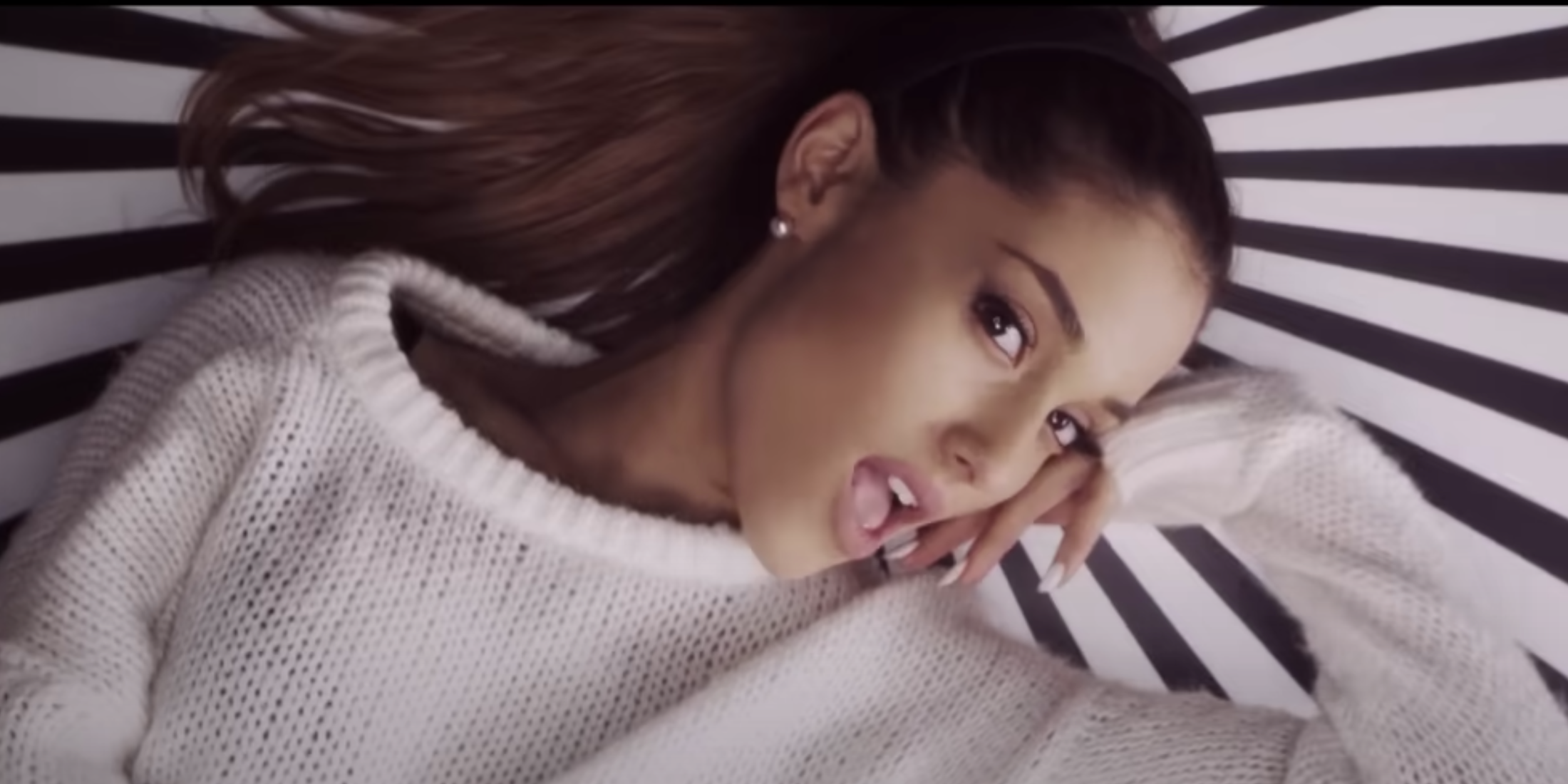 An image of Ariana Grande lounging in the music video for Problem.