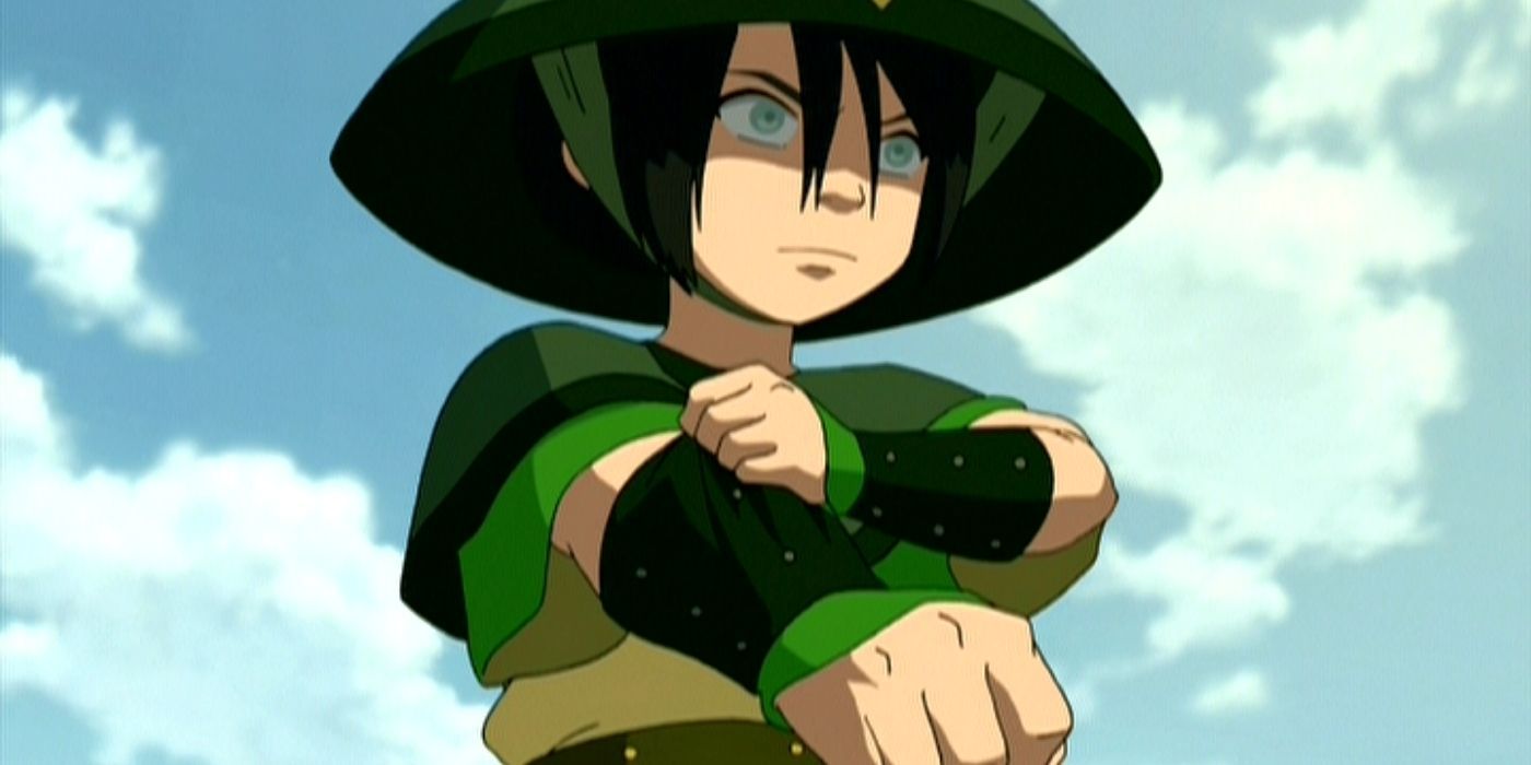 Toph tightens her gauntlets under a cloudy blue sky in Avatar The Last Airbender.