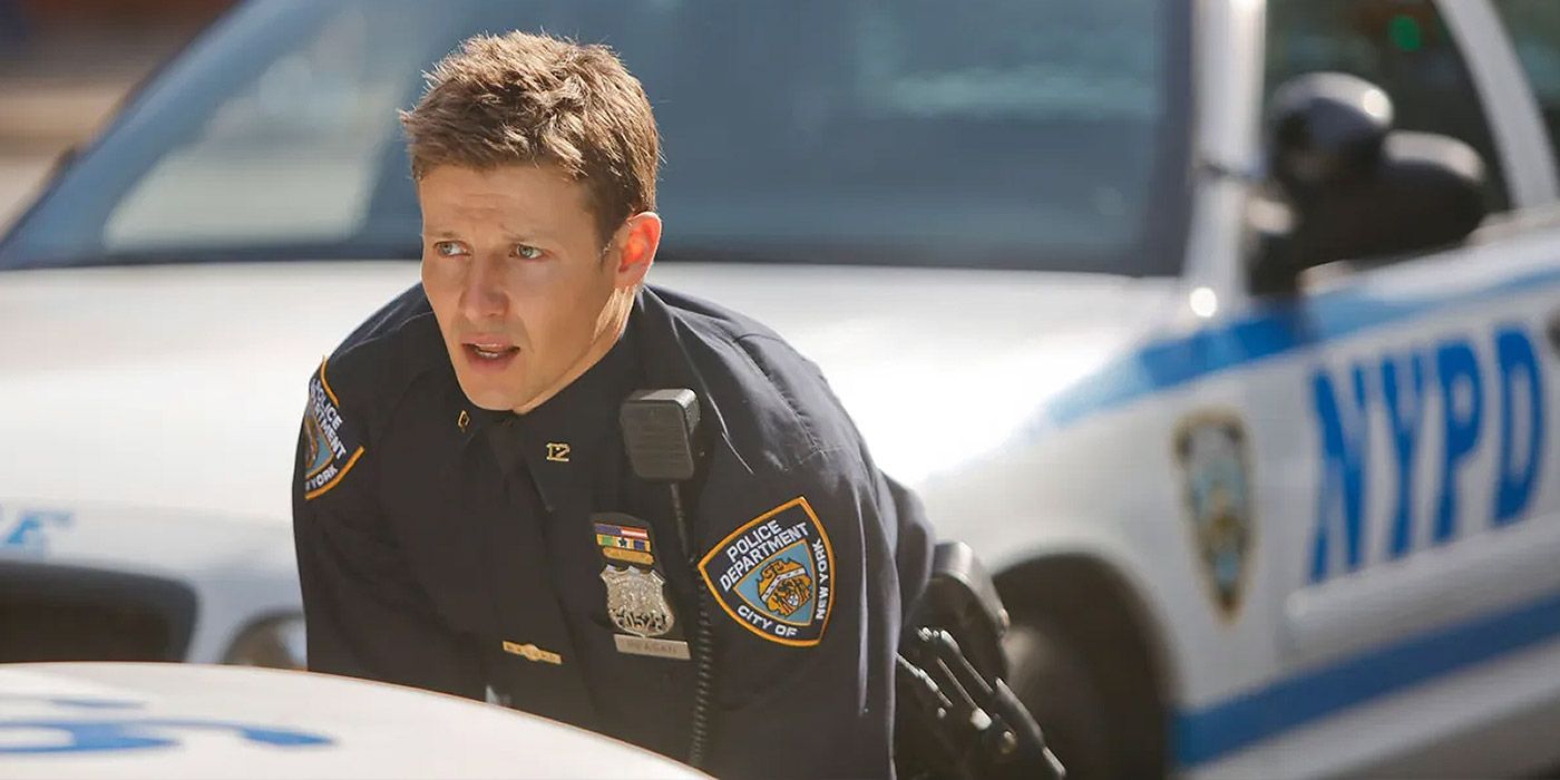Jamie Reagan (Will Estes) behind a police car in Blue Bloods