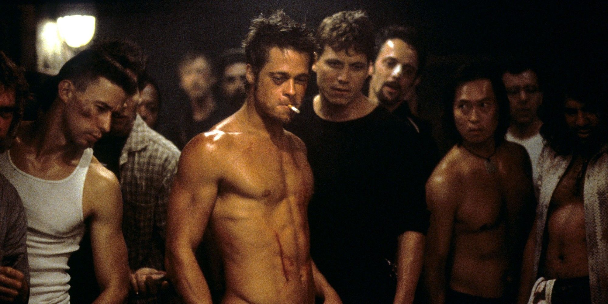 Shirtless Tyler Durden looking down at something in Fight Club