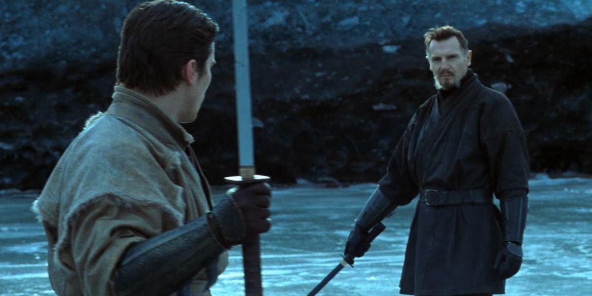 Bruce Wayne and Ra's al Ghul dueling with swords drawn on thin ice in Batman Begins