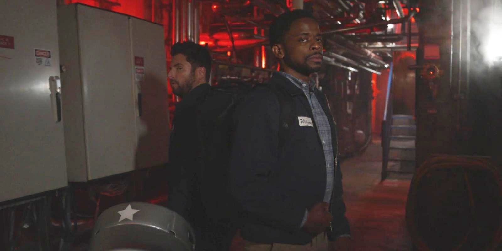 Gus &amp; Shawn stand back-to-back in a warehouse in Psych 3 This Is Gus