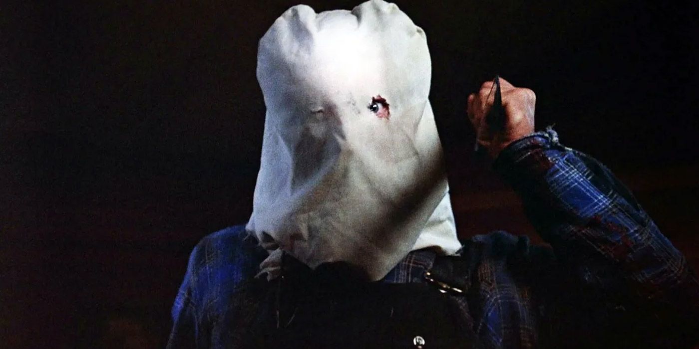 Jason Vorhees wearing a sack on his head and holding a knife in Friday the 13th Part 2